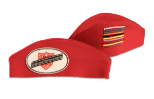 Red felt Service Cap submitted by member. The Cap displays all 8 merit stripes, earned by Junior members for doing good works.
