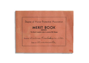 Merit book in which stamps were collected by Service Cap workers upon the completion of good works.